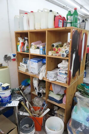 Indhold i reol af diverse rengøringsartikler 