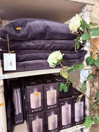 Indhold af reol - Puder, tæpper, lys mm.