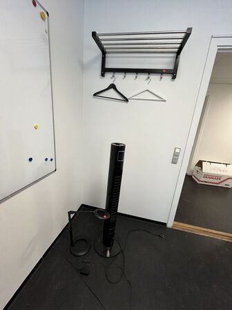 Bordlampe, hattehylde og ventilatortårn.