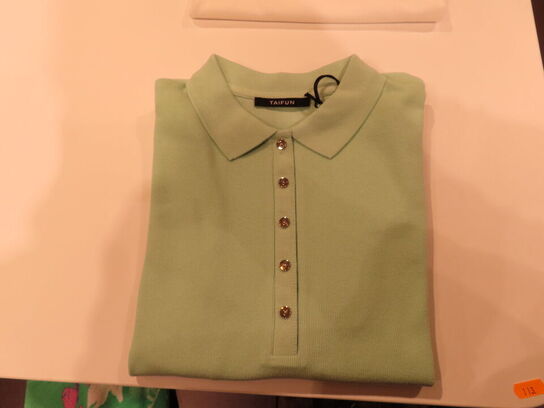 Udstilling med møbler, reol og tøjet på stativer og borde