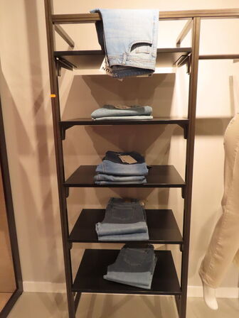 Udstilling med reol, mannequiner og tøjet på reol