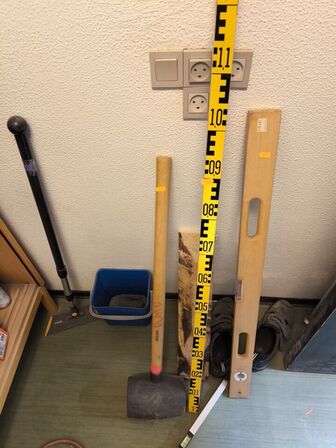 Indhold på reol (PASLODE stifter m.v.) samt hammer, målepind m.m.