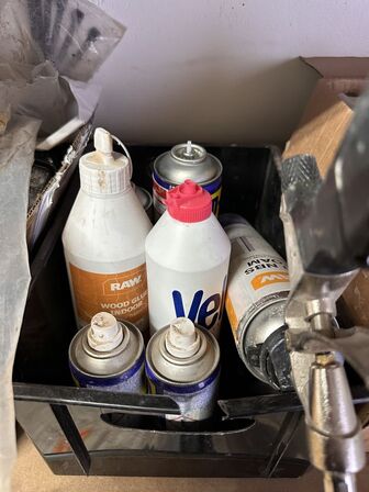 Indhold på reol af diverse spraydåser, fuge mv.