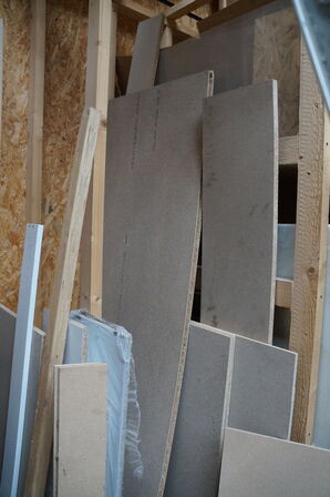 Indhold langs væg af diverse træ, MDF plader mv. 