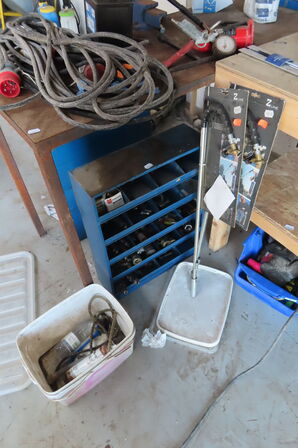 Værkstedsbord med indhold af diverse værktøj, slanger mv.