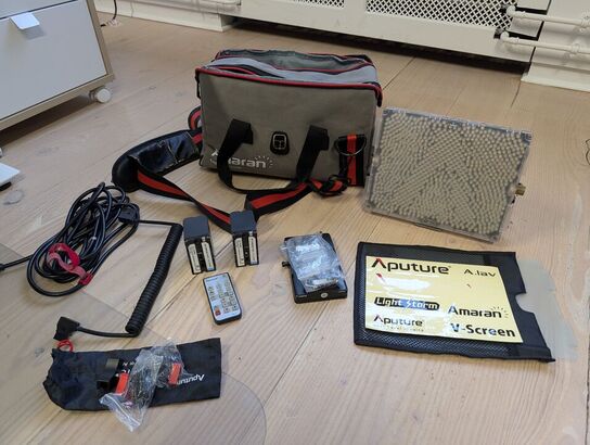 Amaran LED Tri-8C light kit, including panel, batteries, mounting gear, and carrying bag - APUTURE