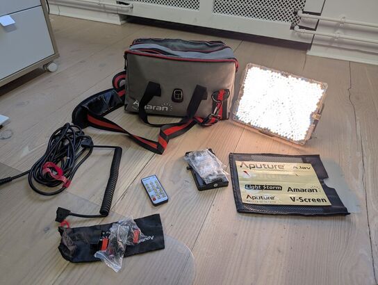 Amaran LED Tri-8C light kit, including panel, batteries, mounting gear, and carrying bag - APUTURE