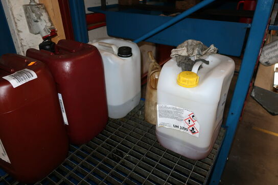 Reol med olietønder (er ret fyldte) samt spildekar