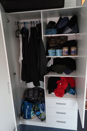 Rum med indhold bl.a. seng, div. Skabe, maleri, vægure m.m.